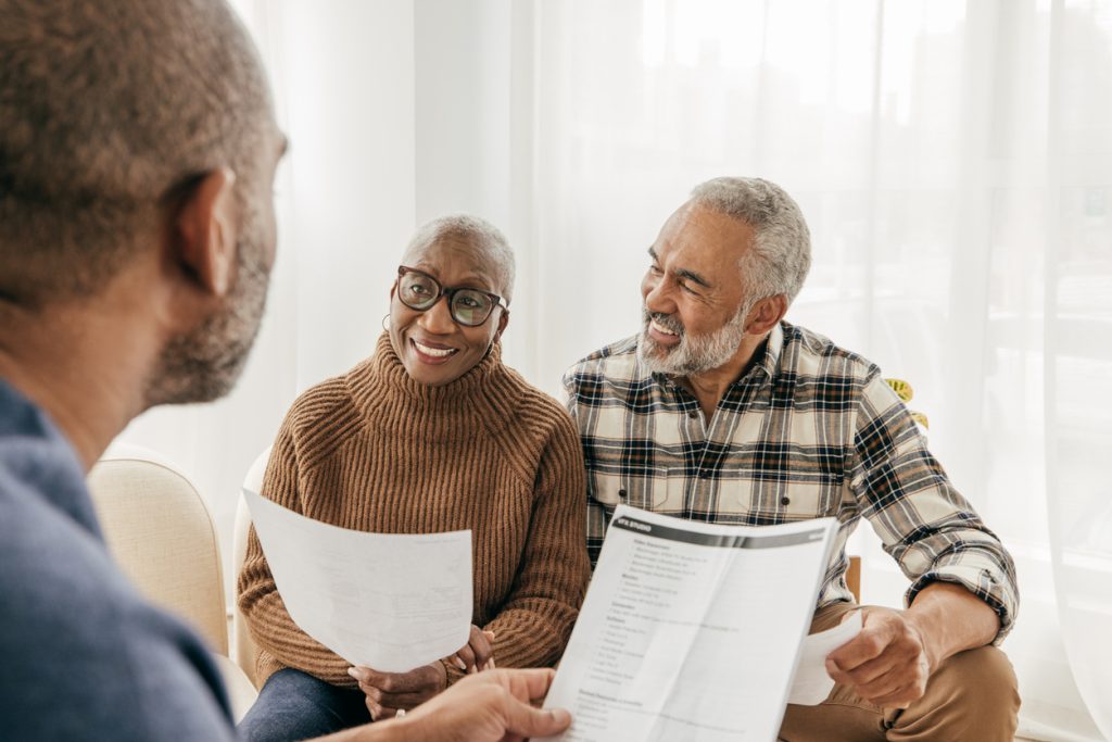 Senior couple working on homecare planning solutions with health care worker 
