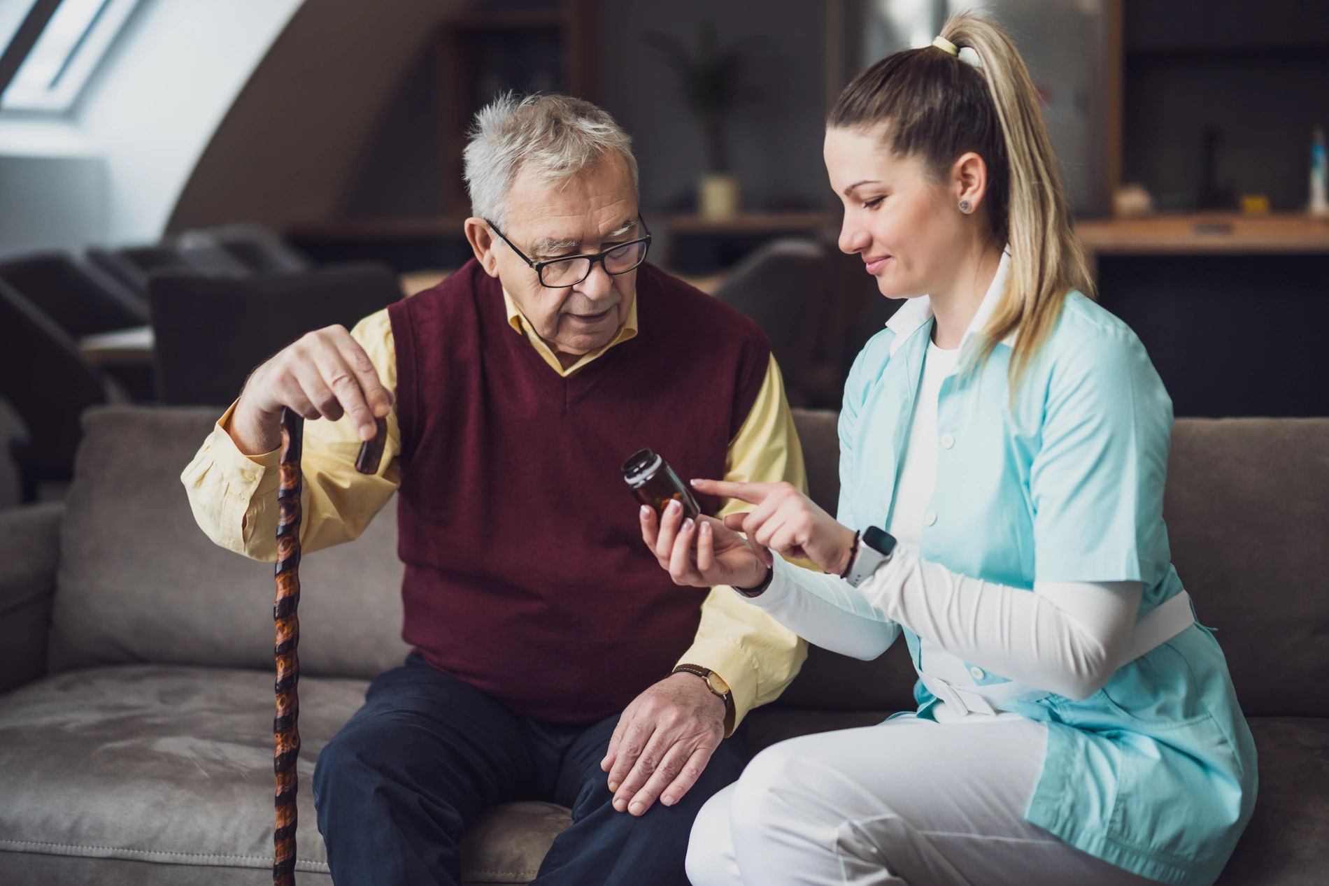 Home Care Lakeside CA caretaker shows elderly man device