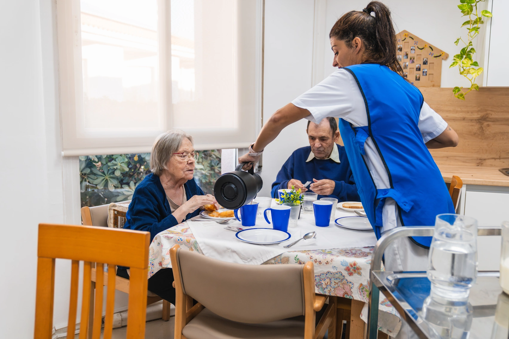 Home Care Santee CA caretaker pouring water for elderly client