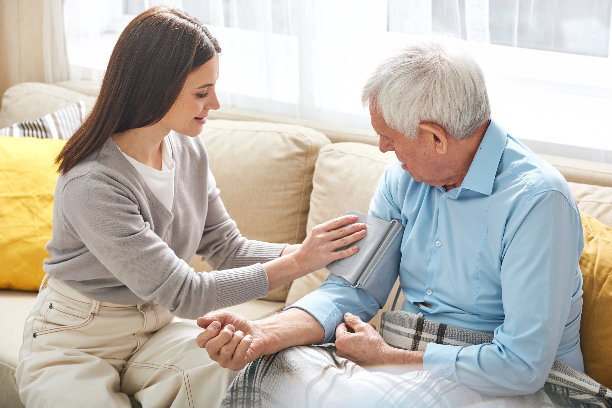 Imperial Beach CA Home Care female caretaker takes blood pressure of male client