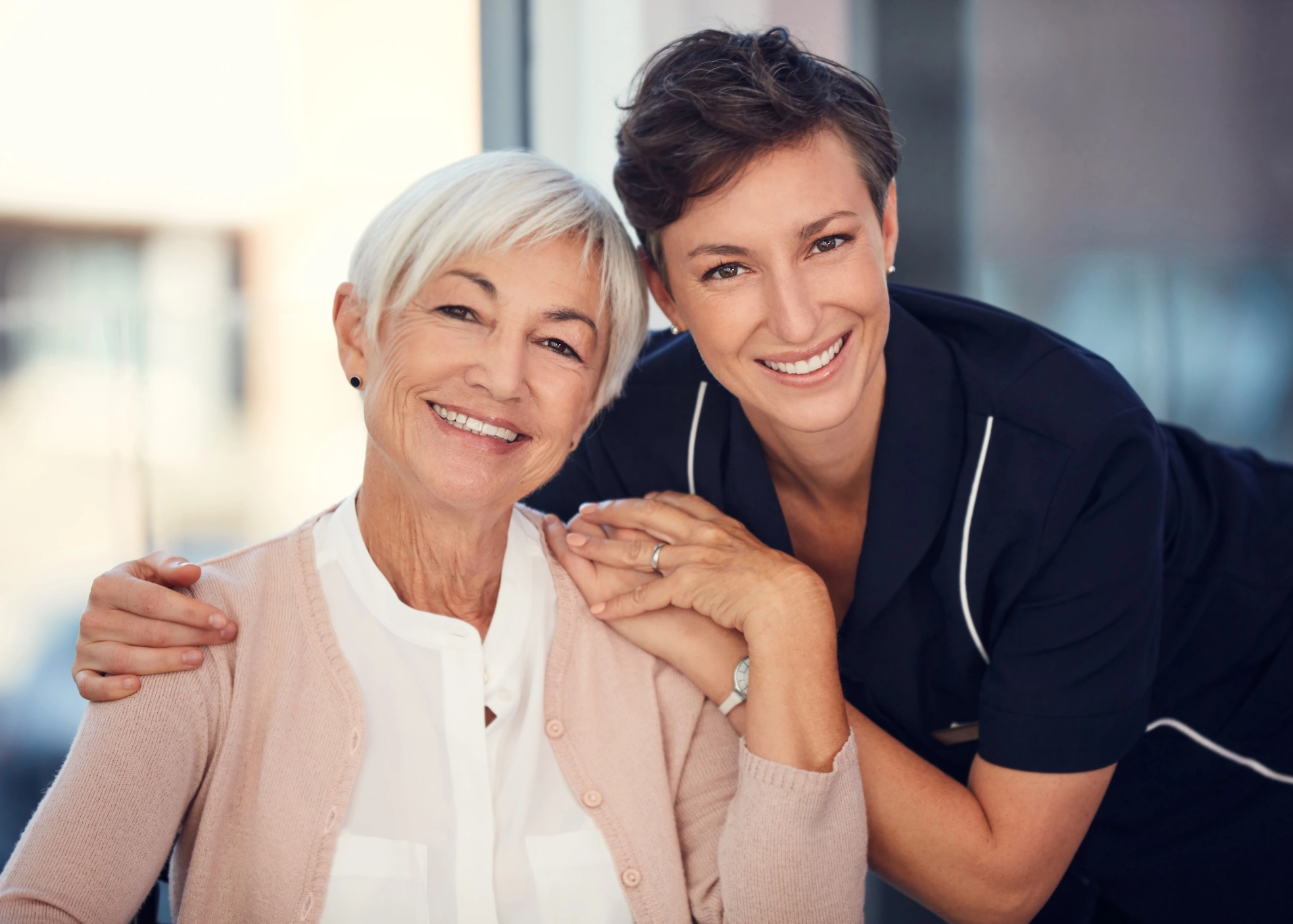 In-Home Care Spring Valley CA caretaker in blue poses with elderly senior female