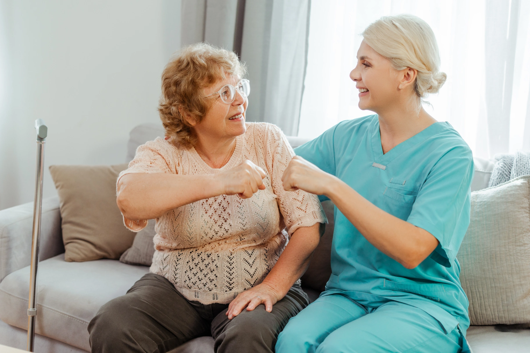 Rancho San Diego CA home care caretaker fists bumps with elderly woman