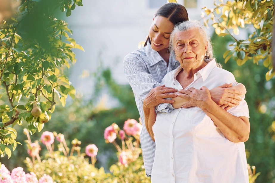 Winter Gardens CA Home Care Hispanic granddaughter hugs her grandmother